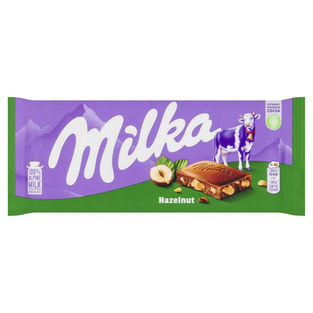 Milka Hazelnut chocolate, chocolate with hazelnuts, Milka 100g bar, European chocolate, Milka Alpine milk chocolate, creamy nutty chocolate, hazelnut candy bar, Milka snack, imported Milka chocolate, nut-filled chocolate.